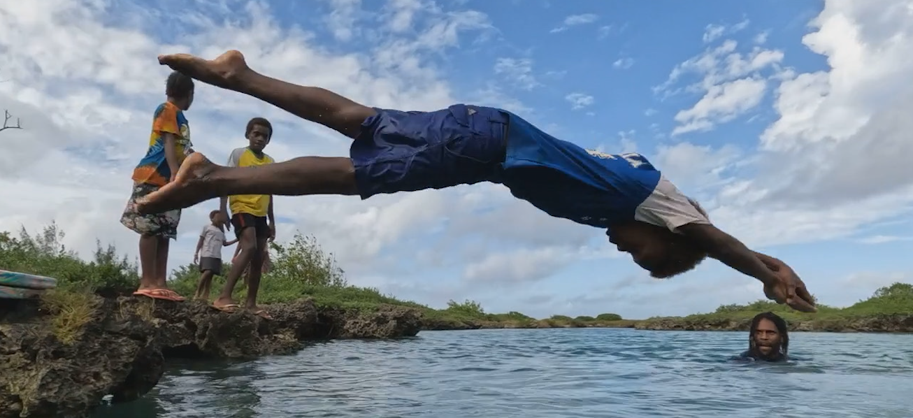 A child in Vanuatu diving into the water