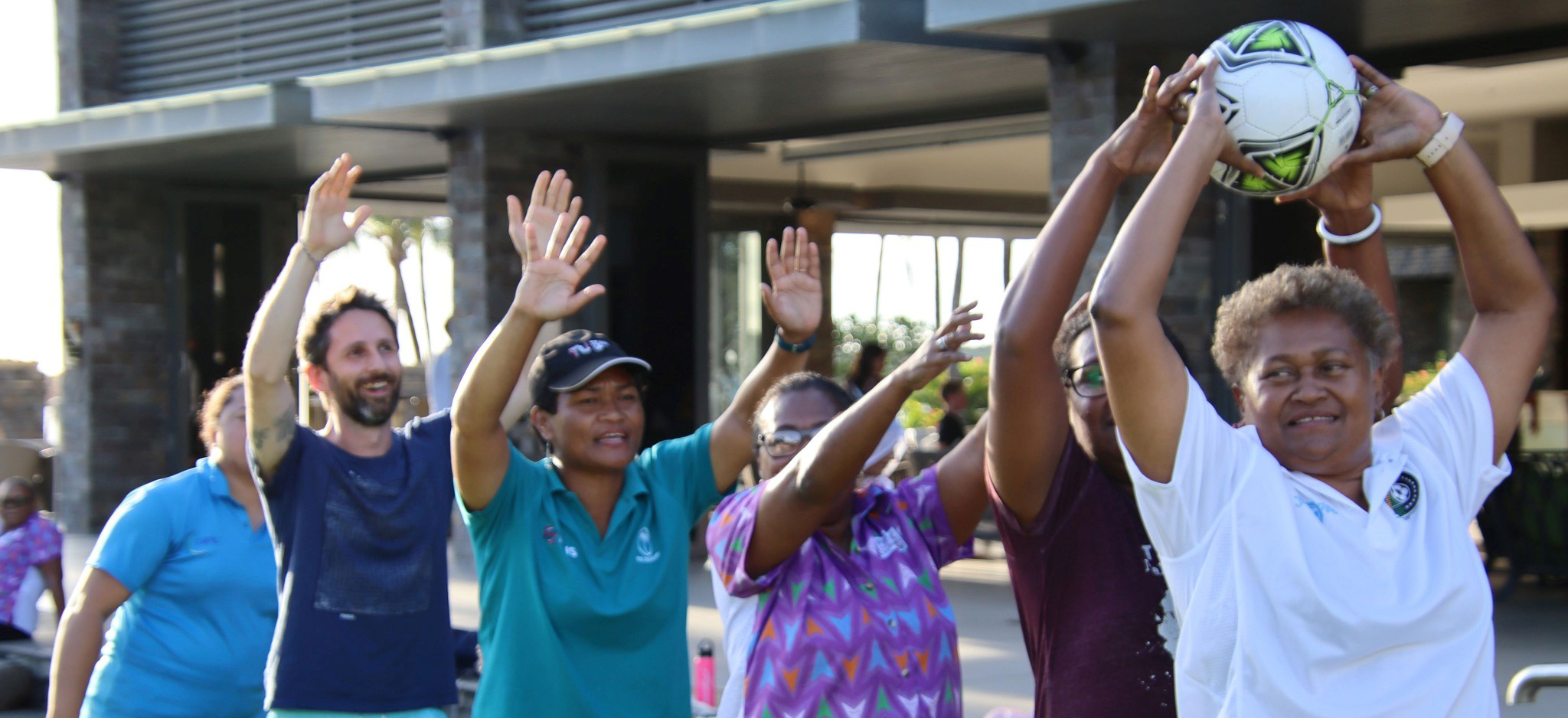 People in Fiji doing a group activity with a football