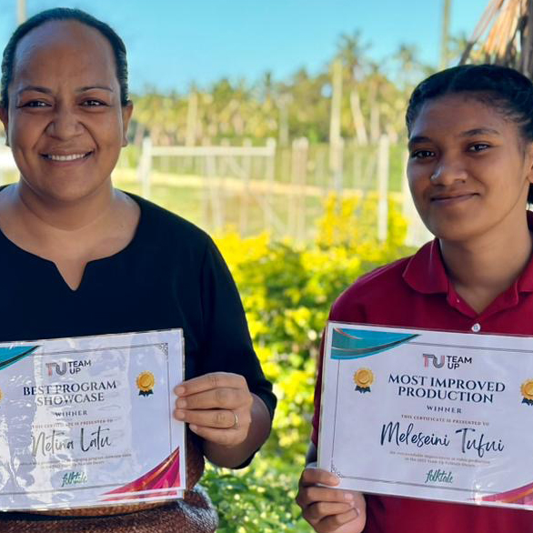 Two women in Tonga holding certificates