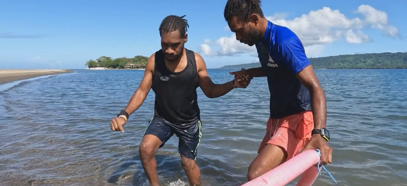 A man with a disability taking part in a swimming lesson