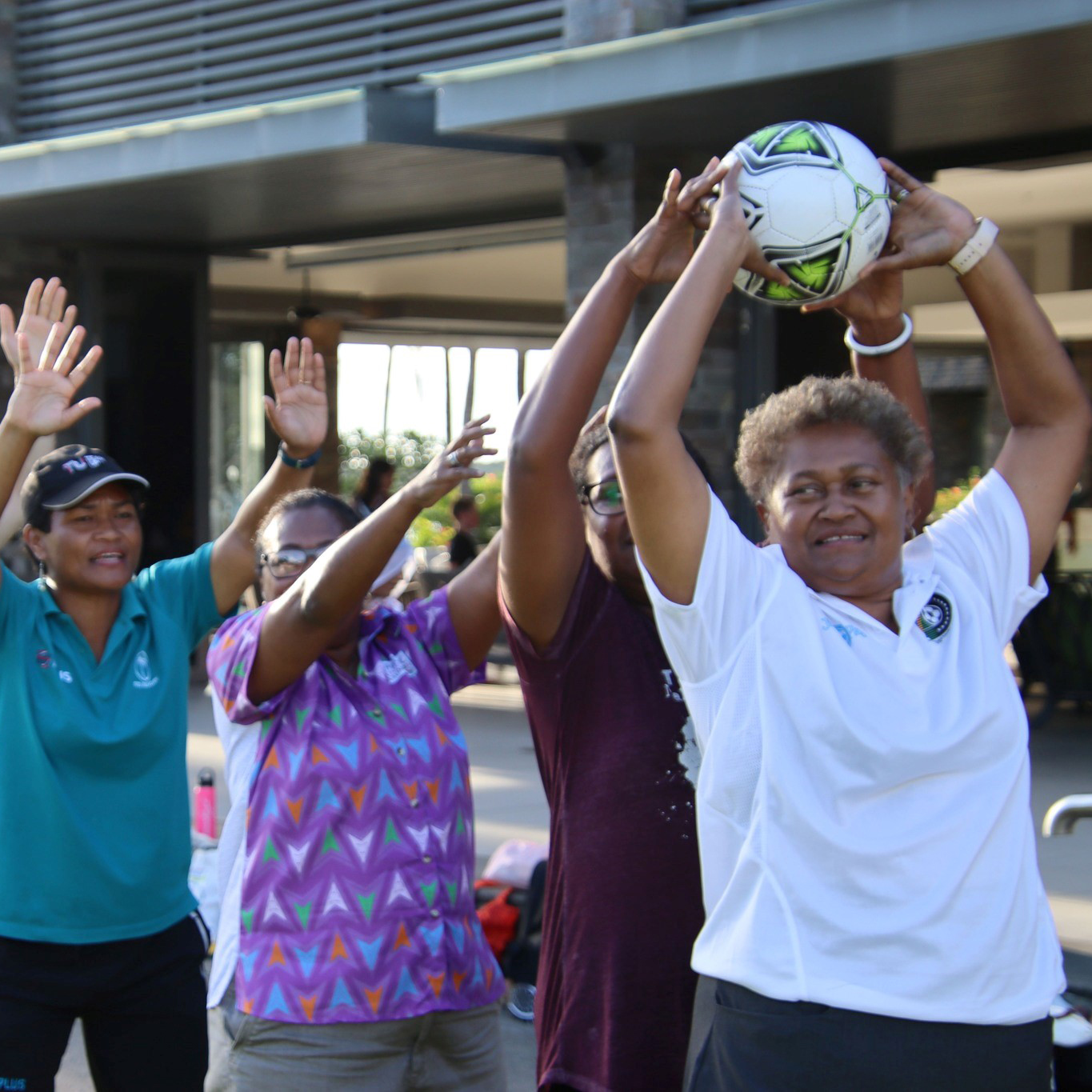People in Fiji doing a group activity with a football