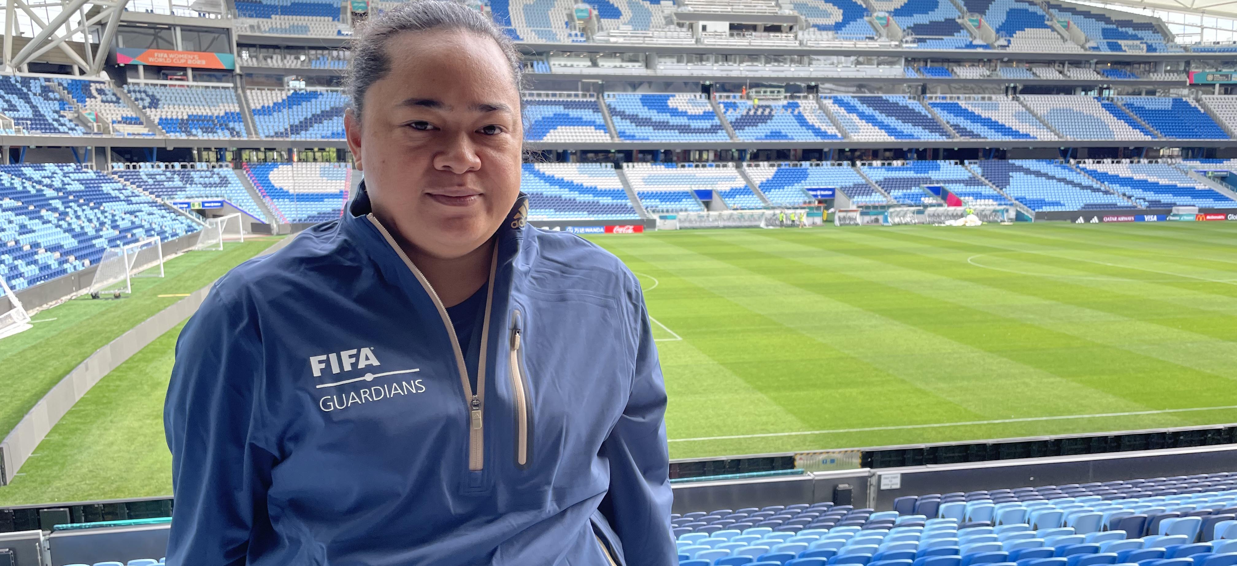 A woman from Tonga posing for a photo at a stadium in Australia.