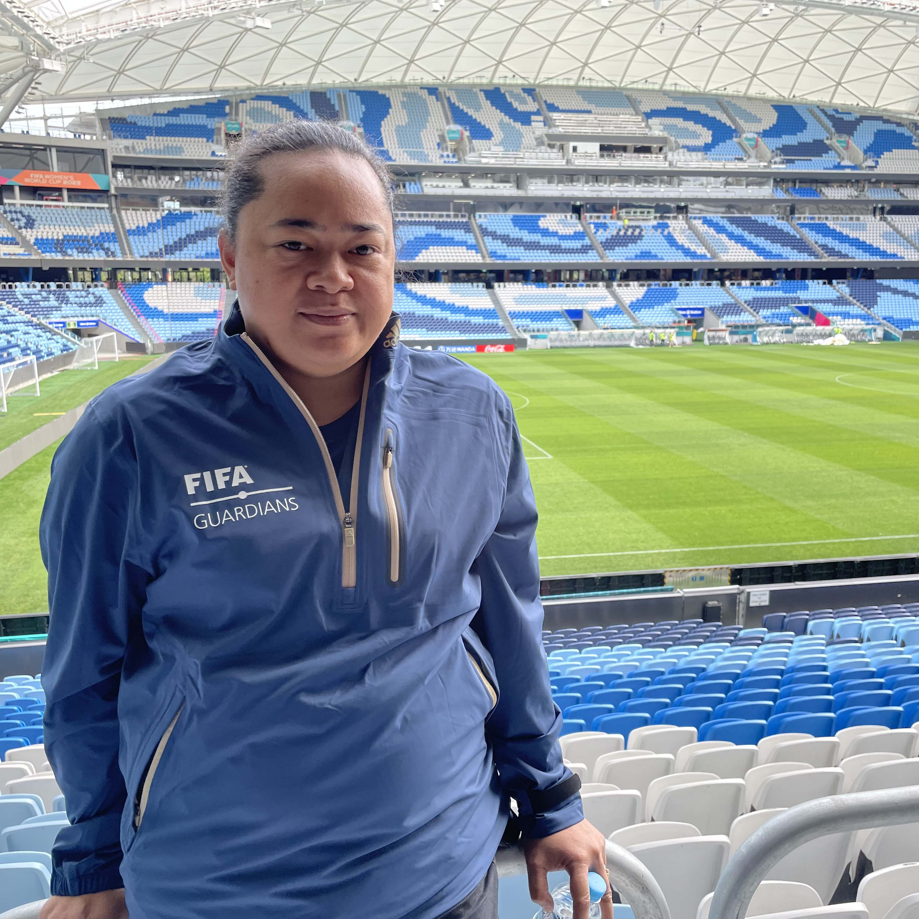 A woman from Tonga posing for a photo at a stadium in Australia.
