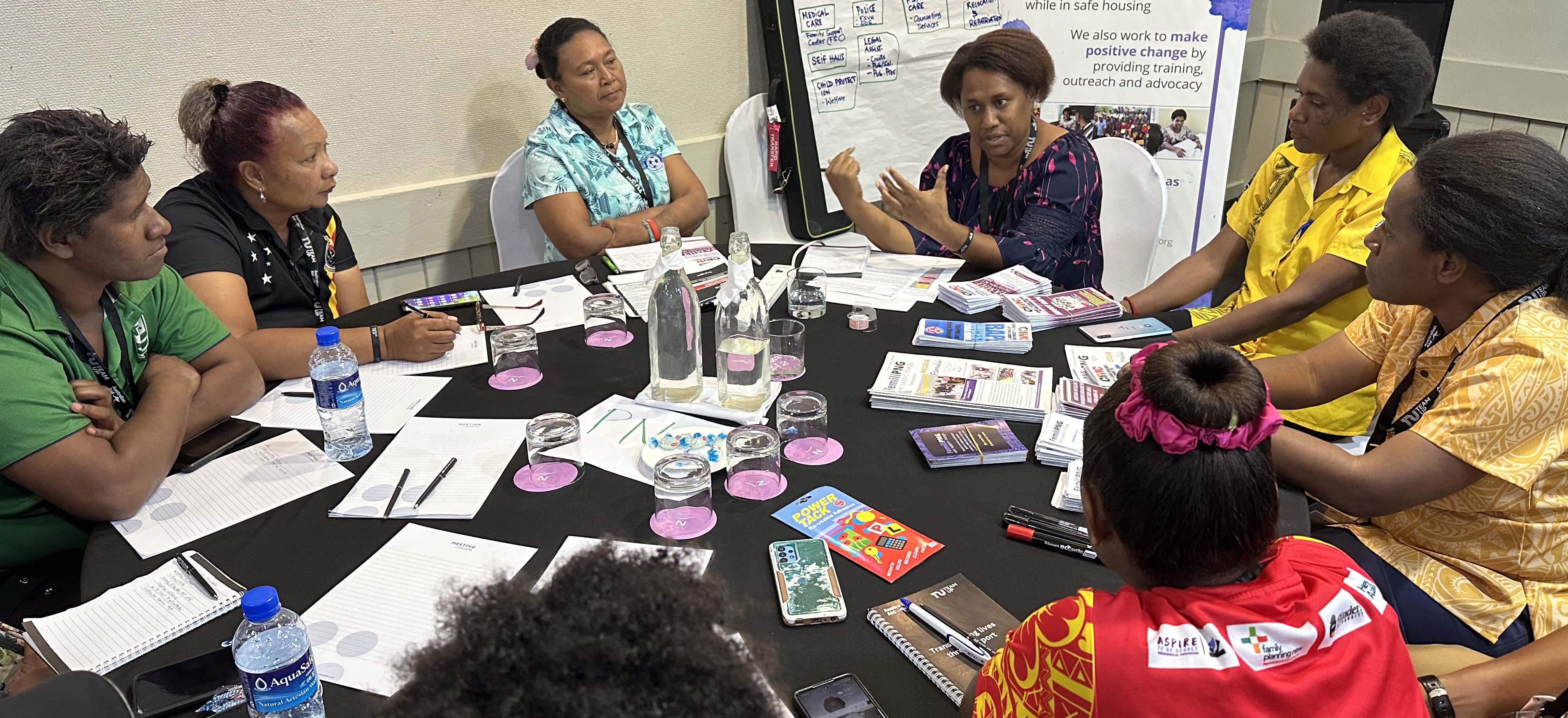 People sitting around a table at a workshop