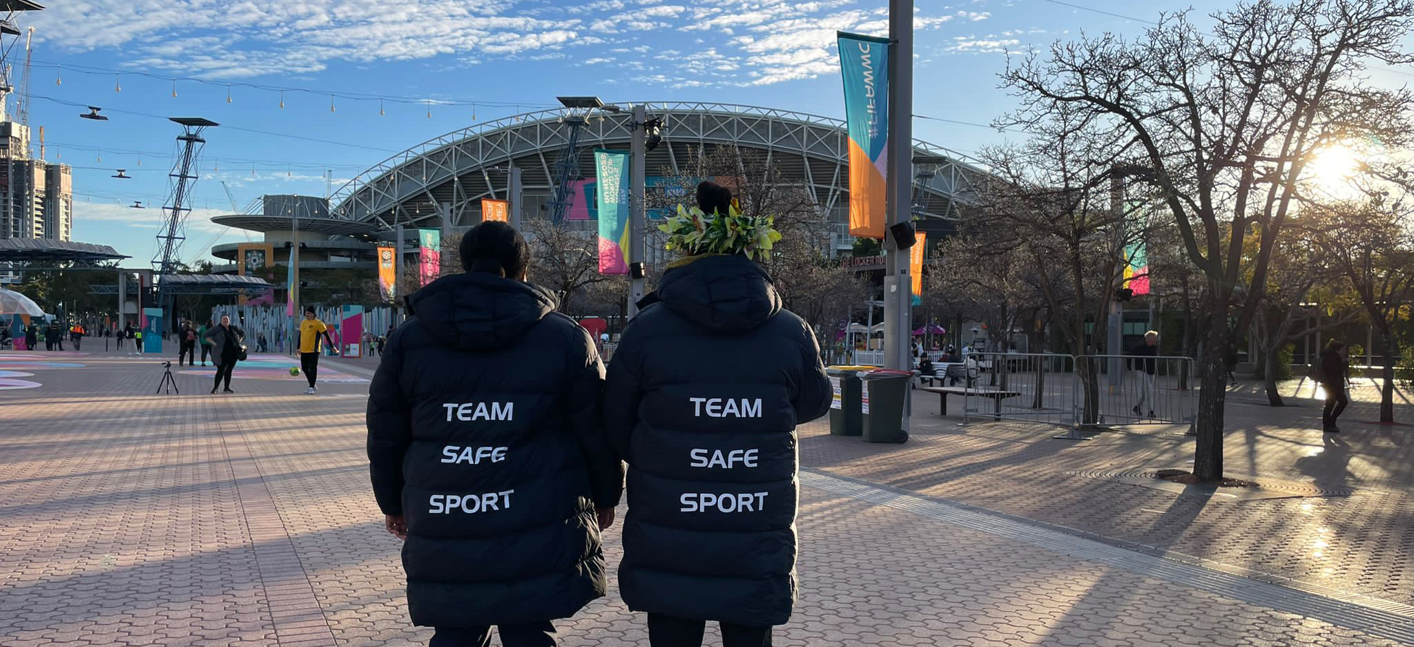 Two women standing outside a stadium