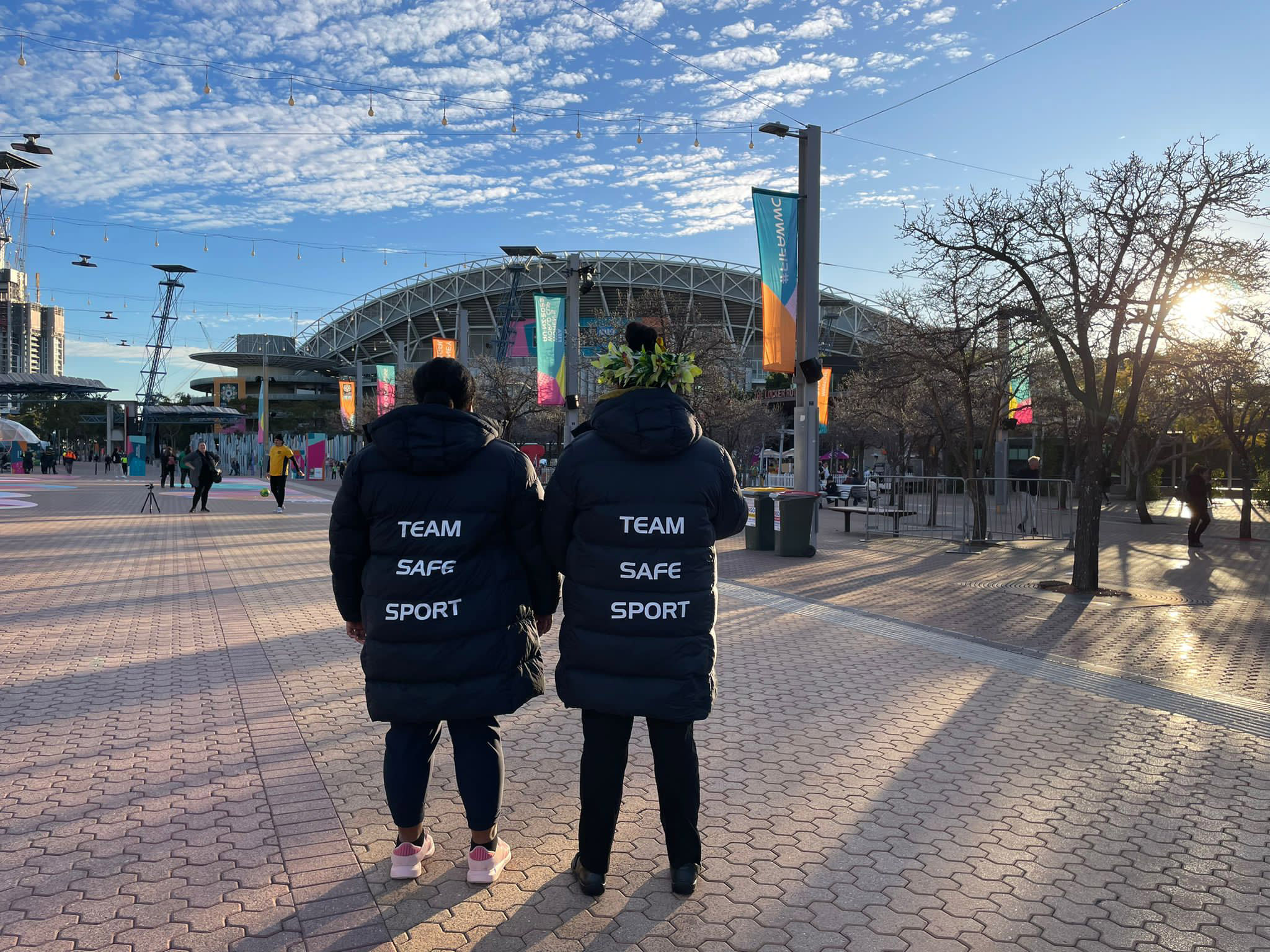 Two women standing outside a stadium