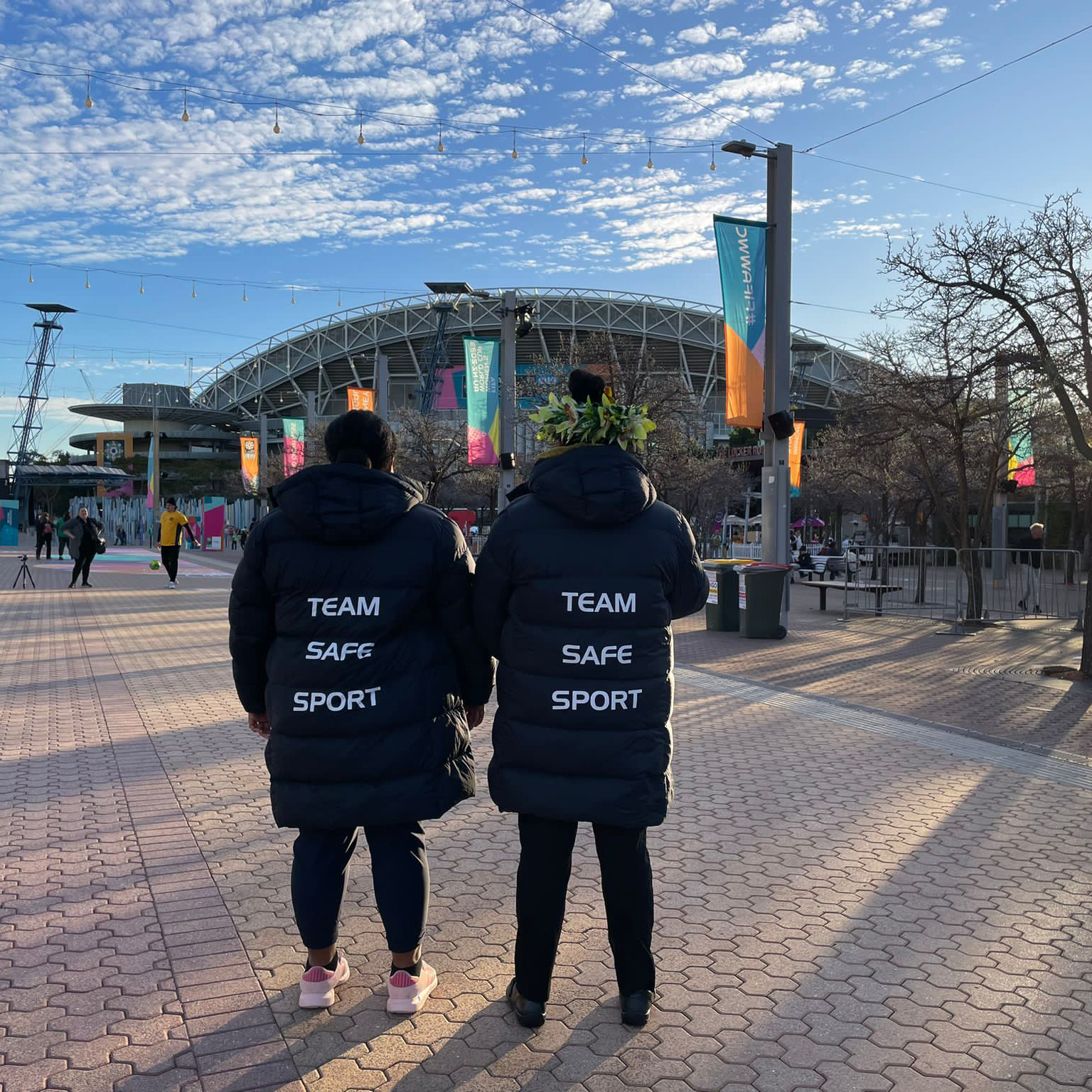 Two women standing outside a stadium