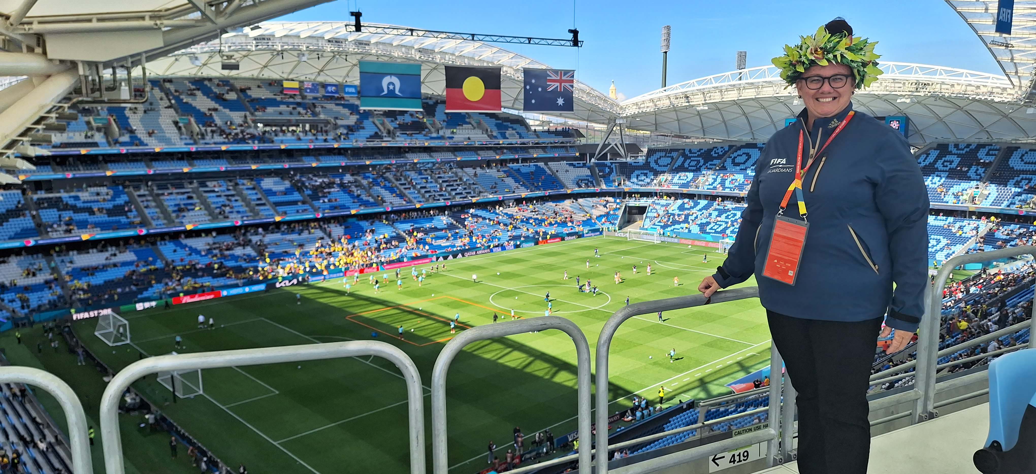 A woman standing in an empty stadium