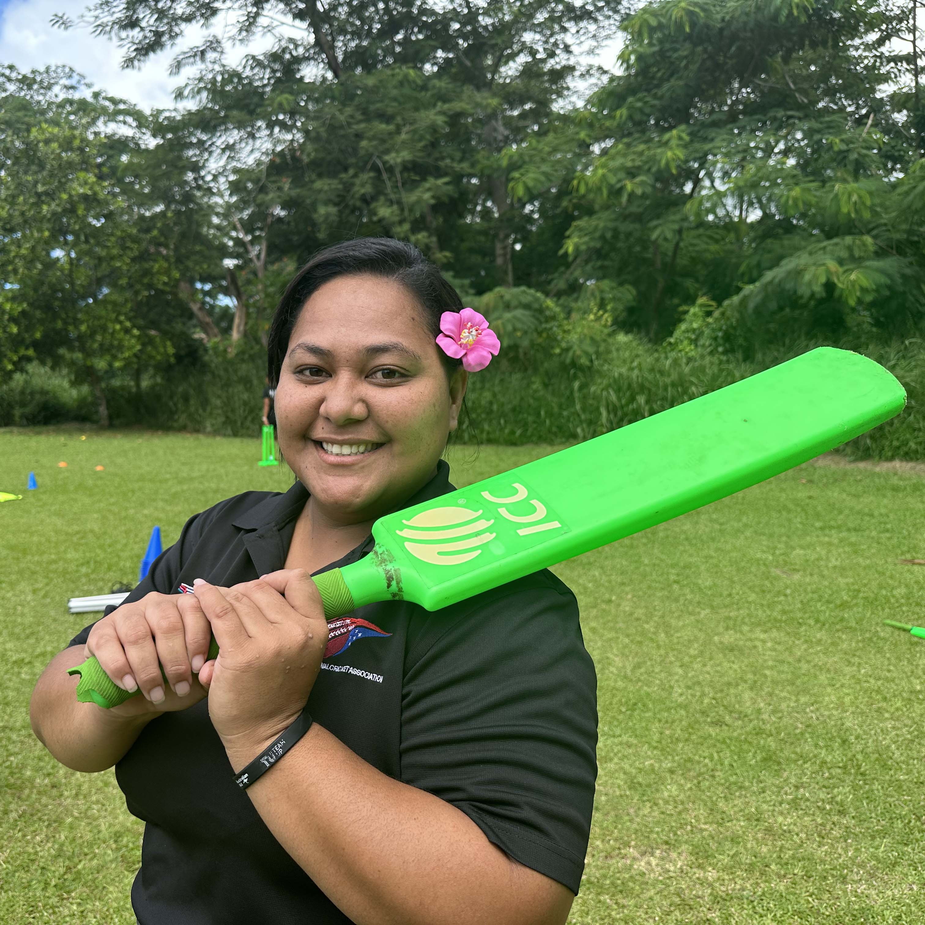 A woman in Samoa holding a cricket bat