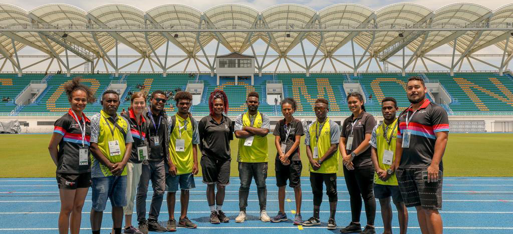 A group of people posing for a photo at stadium