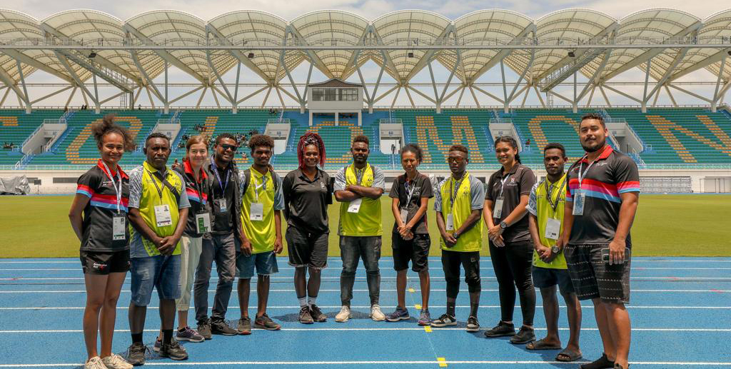 A group of people posing for a photo at stadium