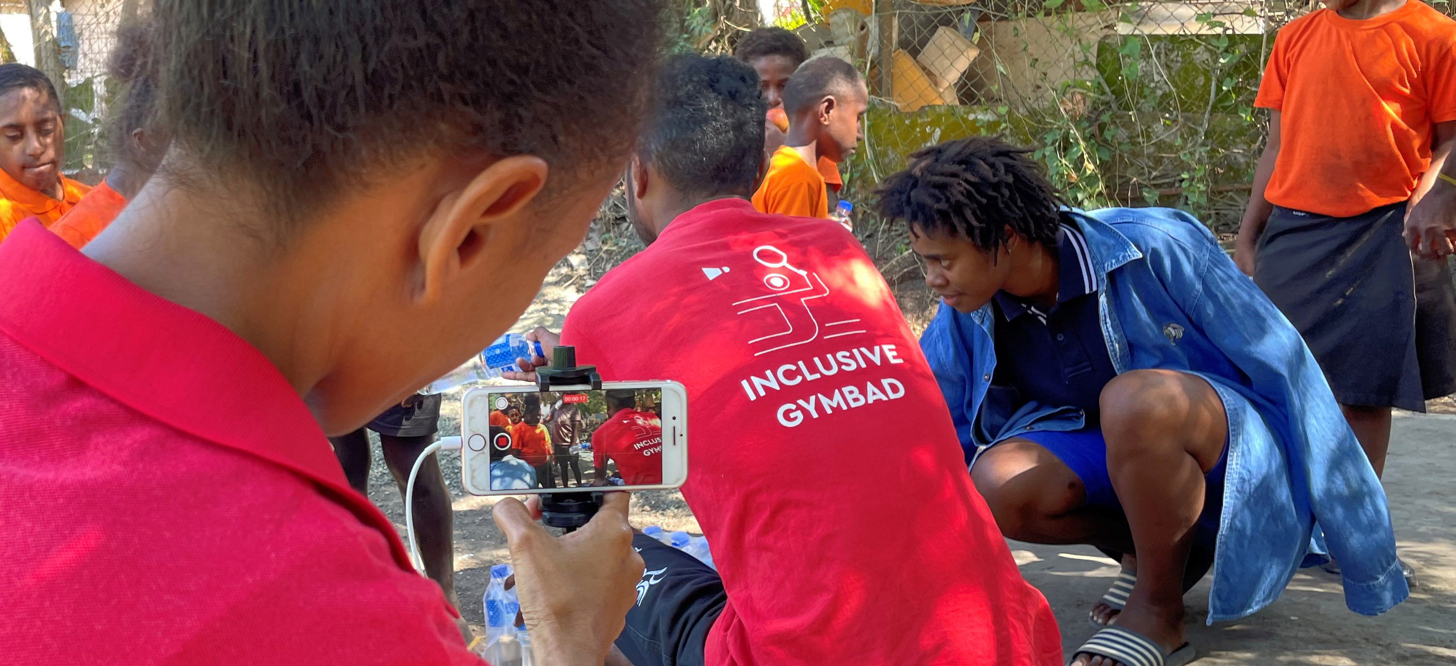 A woman filming on a mobile phone