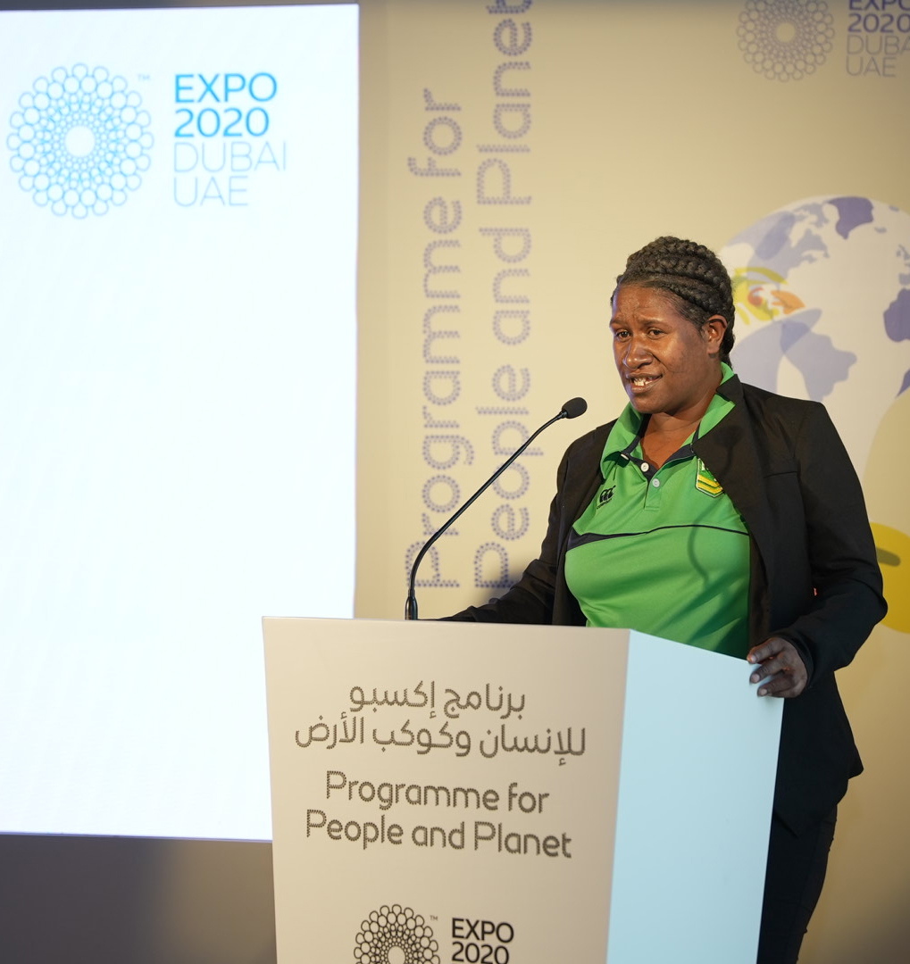 A woman speaking at a podium