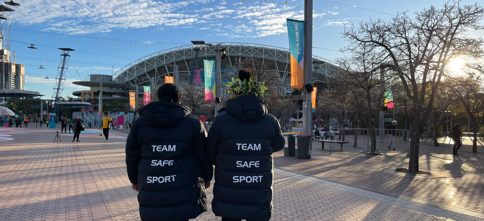 Two women standing outside a stadium