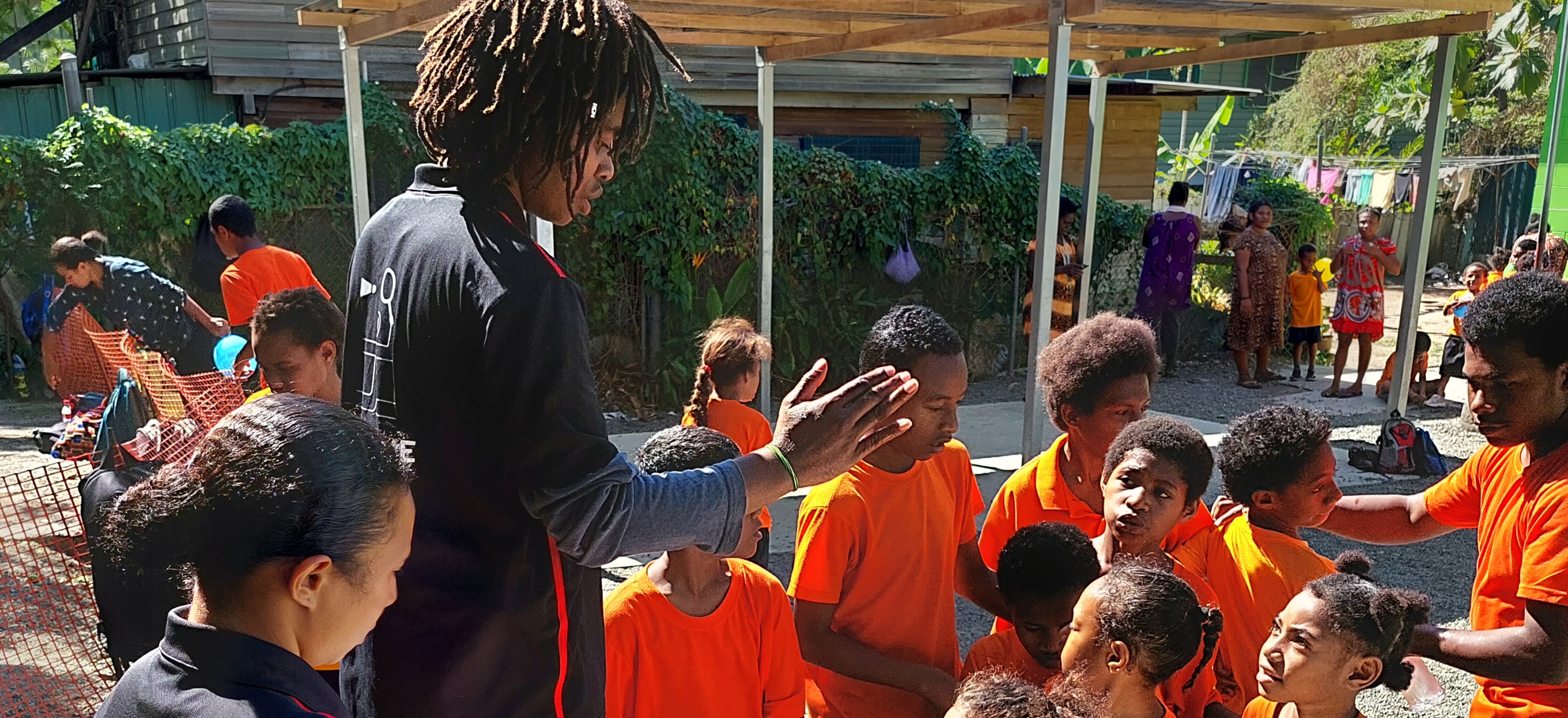Children in PNG learning badminton