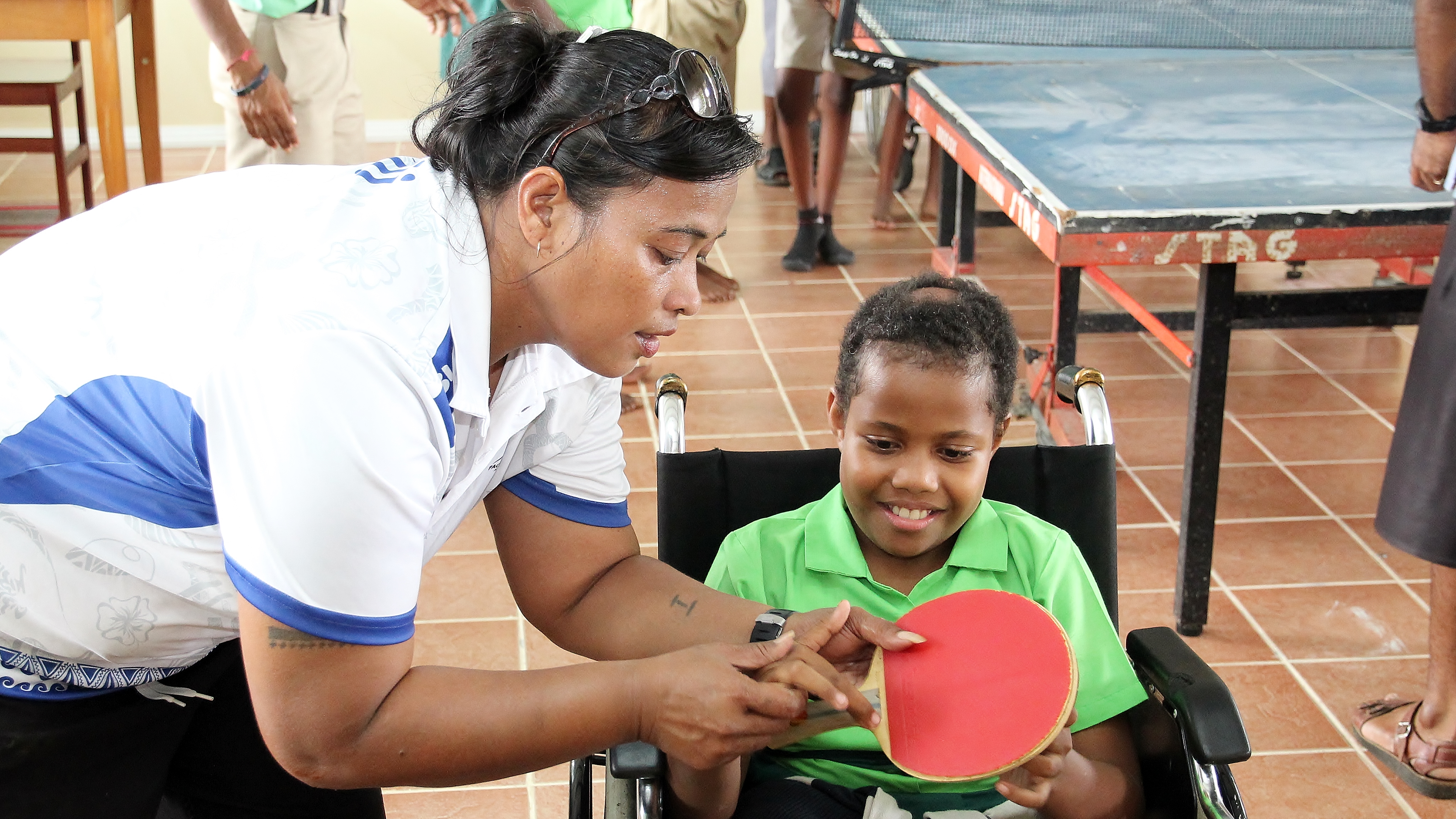 Young boy in Fiji learns to play table tennis