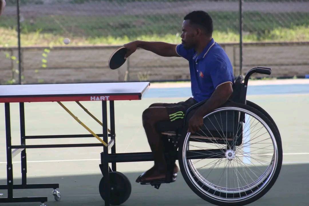 A boy with a disability plays table tennis