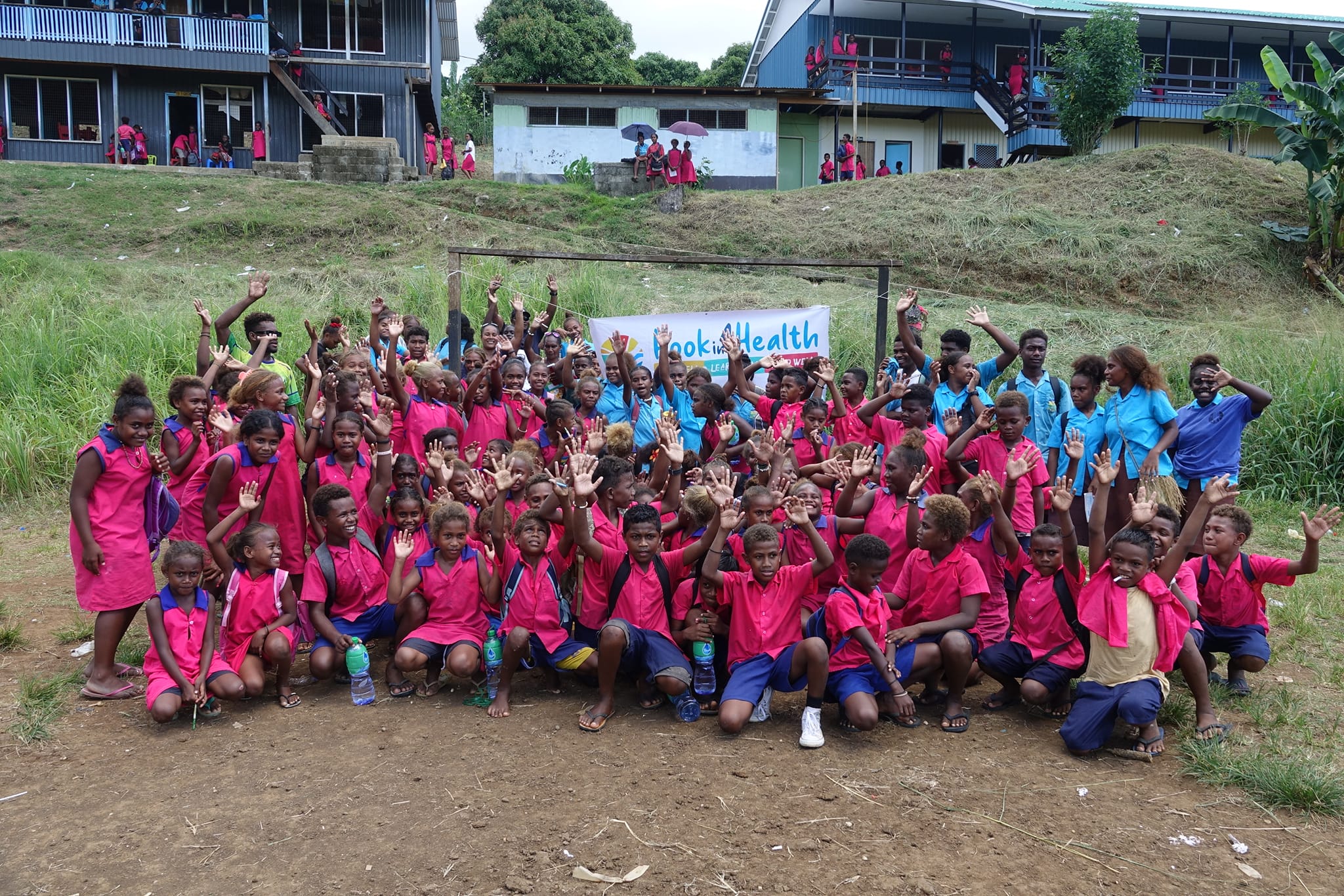 School children celebrate after playing hockey 