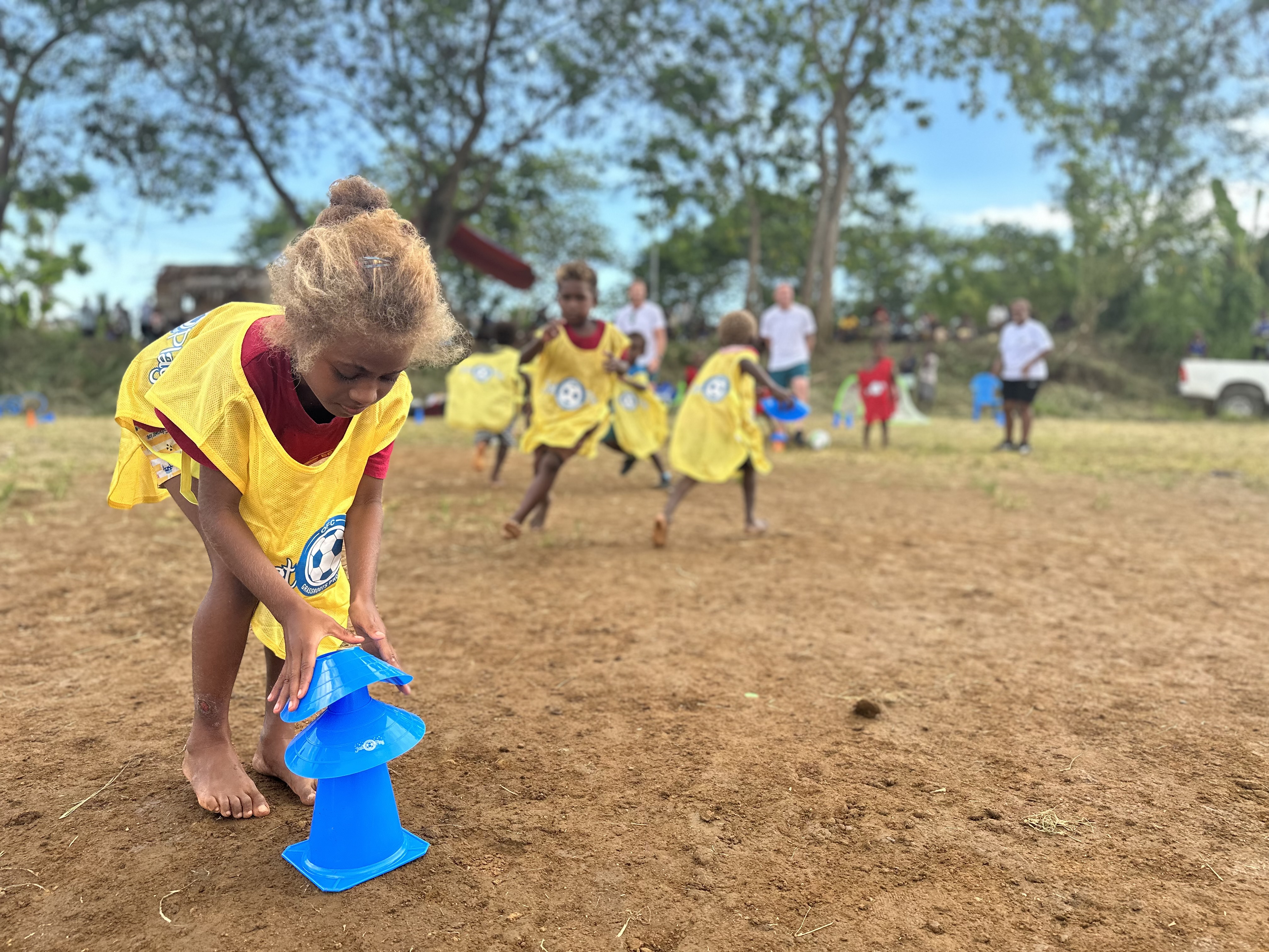 A young girl sets up to play football