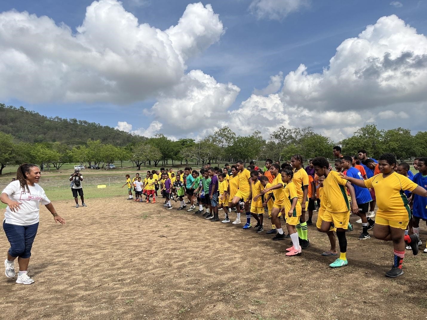 Teams lined up and ready at the start of the Special Olympics PNG Unified football competition at the University of Papua New Guinea sports field. 