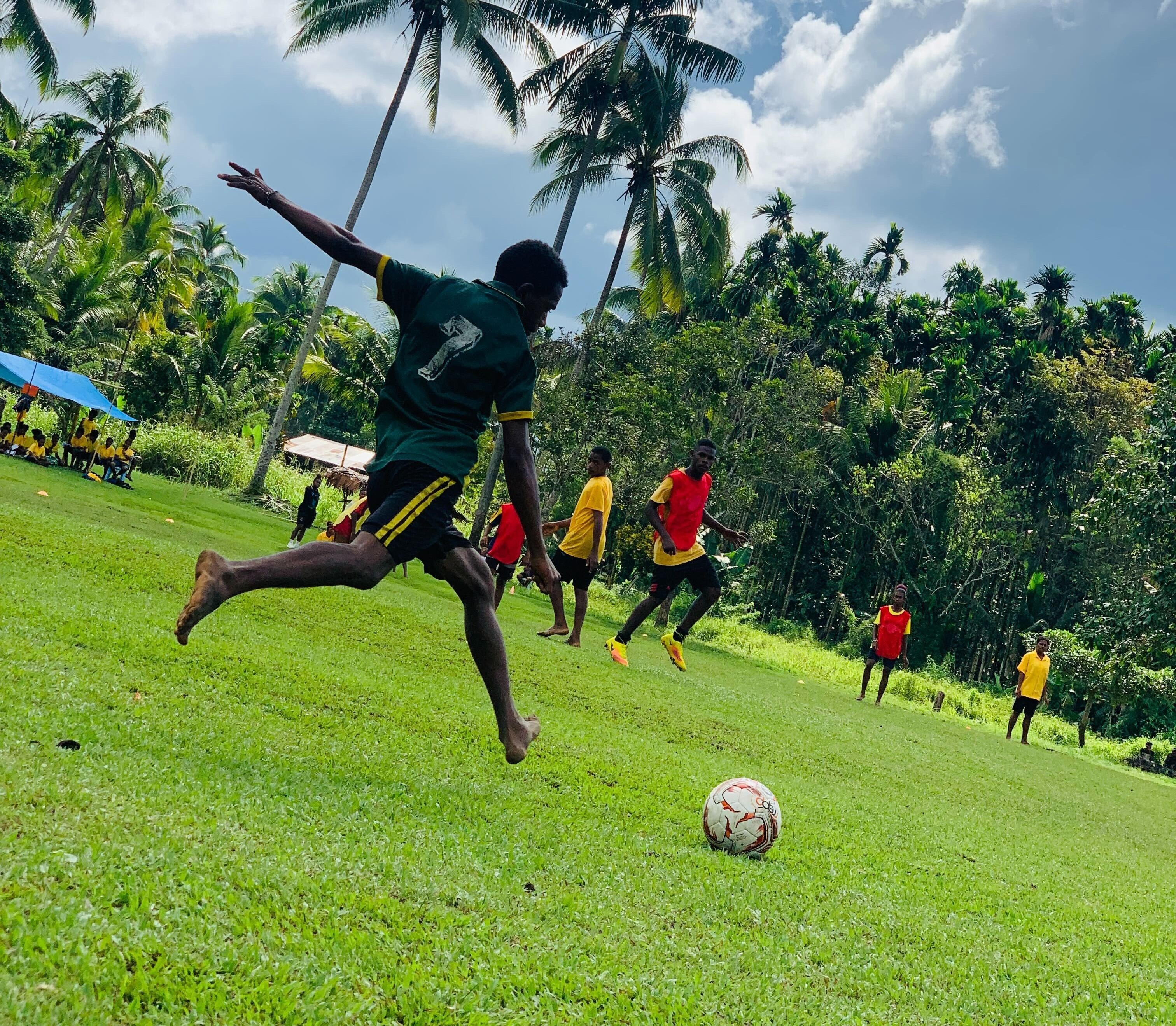 Action shot of a K4K Participant mid-kick of the soccer ball