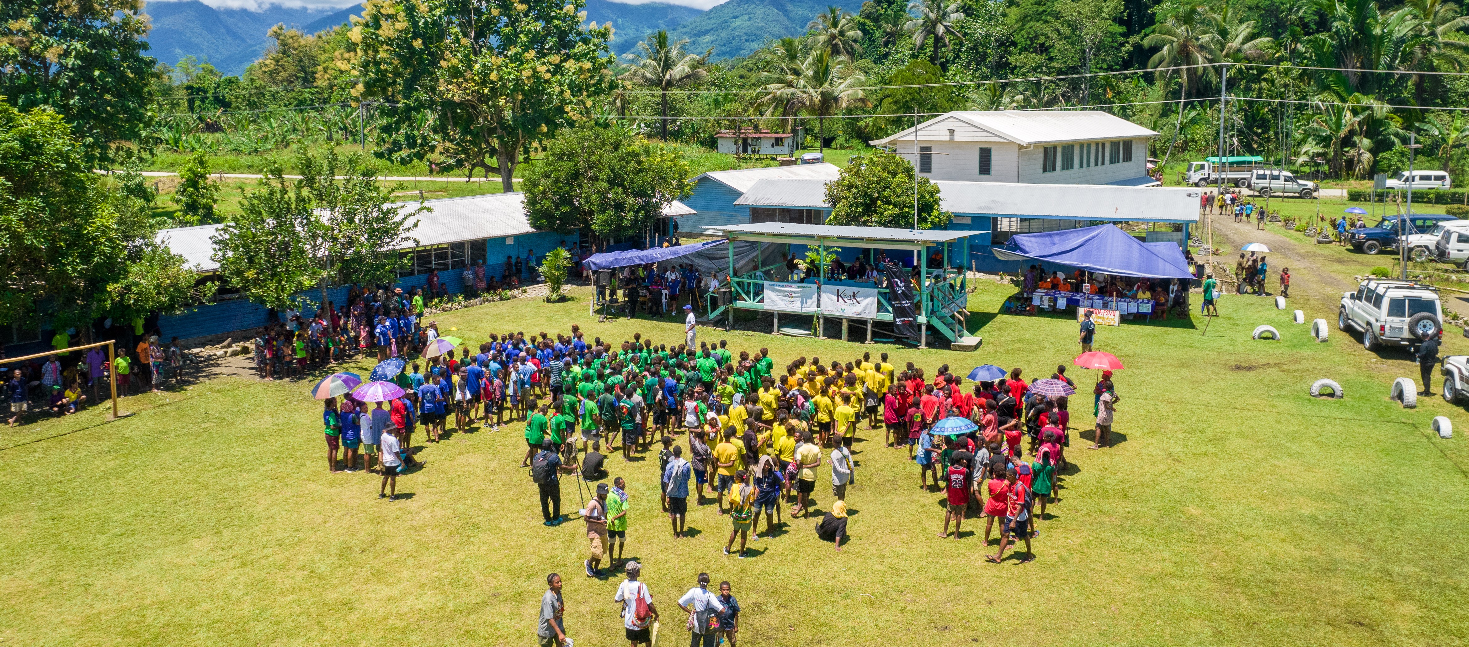 : Aerial photo of a Kicks 4 Kokoda tournament, with the four teams highlighted through different coloured shirts