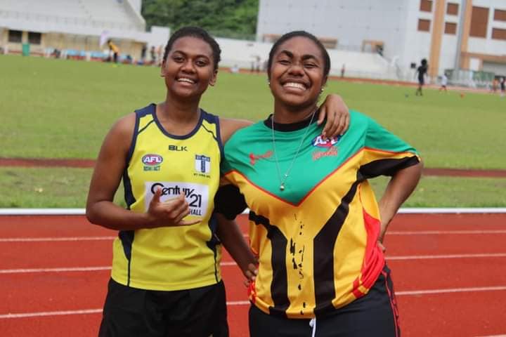 twi female athletes smiling